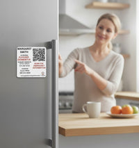 Speak For Me Systems emergency QR code magnet on a refrigerator with medical contact details for first responders