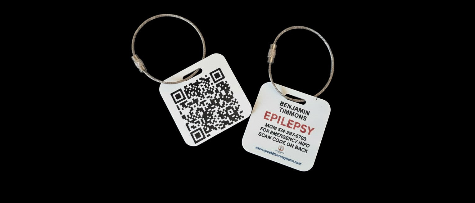 Speak For Me Systems square medical ID tag with QR code and emergency contact information on a steel cable ring.