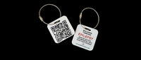 Speak For Me Systems square medical ID tag with QR code and emergency contact information on a steel cable ring.